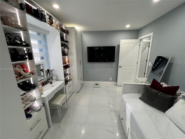 interior space with recessed lighting, baseboards, and marble finish floor