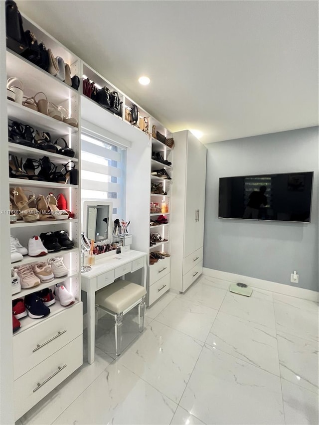 spacious closet with marble finish floor