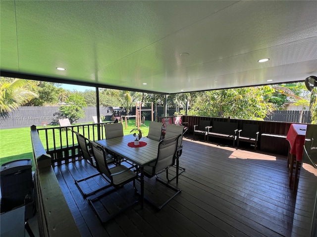 deck featuring a yard, a fenced backyard, and outdoor dining space