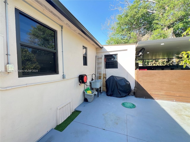 view of patio with area for grilling and visible vents