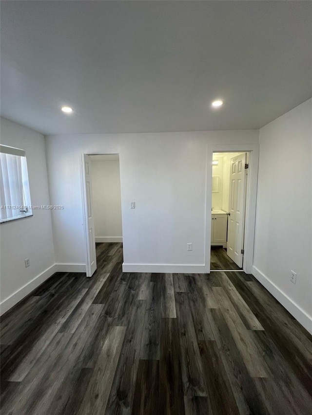 interior space with recessed lighting, baseboards, and dark wood-type flooring