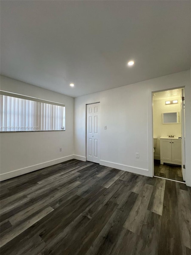 unfurnished bedroom featuring dark wood-style floors, recessed lighting, and baseboards