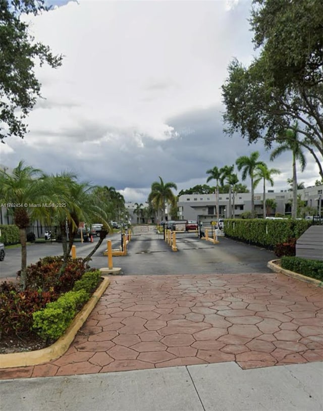 view of road featuring curbs and a gated entry