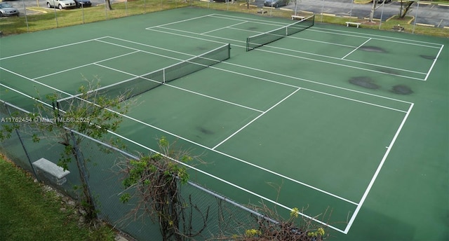 view of tennis court featuring fence