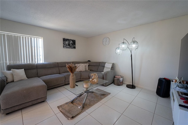 tiled living room featuring baseboards and a textured ceiling