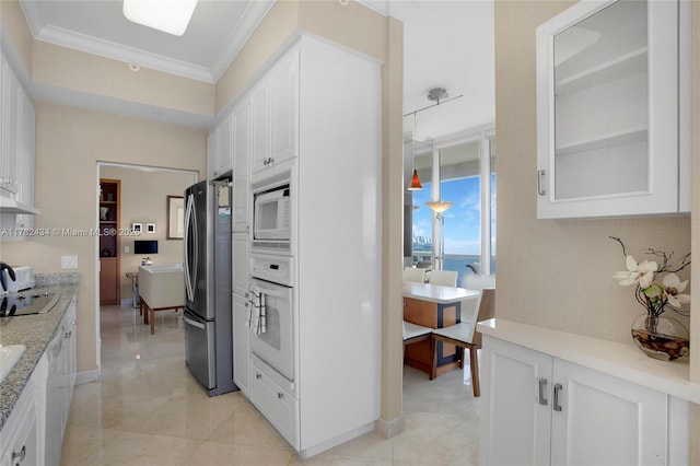 kitchen featuring tasteful backsplash, crown molding, light stone countertops, white appliances, and white cabinetry