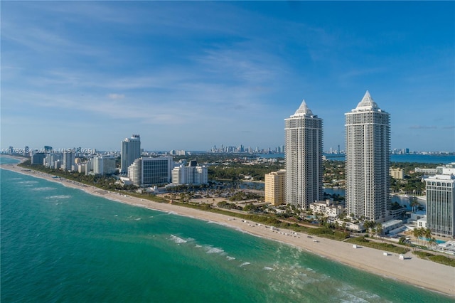 birds eye view of property with a water view, a city view, and a beach view