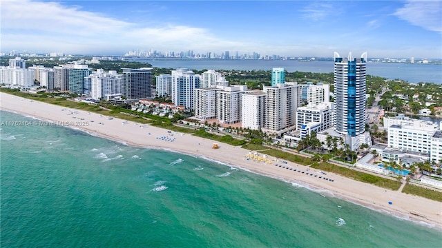 drone / aerial view with a view of city, a view of the beach, and a water view