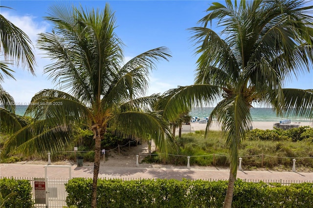 view of property's community featuring a water view and fence