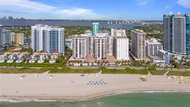 bird's eye view with a city view, a beach view, and a water view