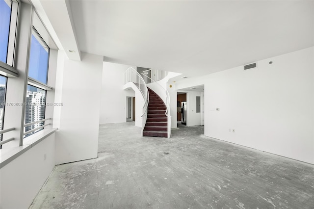 1395 Brickell Ave Unit 3403, Miami, FL 33131 - unfurnished living room with visible vents and stairs