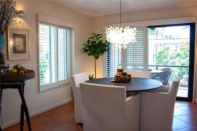 dining room with light tile patterned floors, baseboards, and a notable chandelier