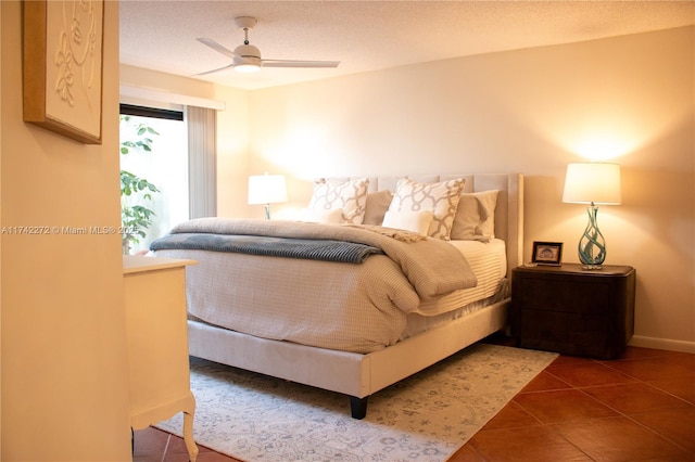 bedroom featuring a textured ceiling, a ceiling fan, and tile patterned flooring