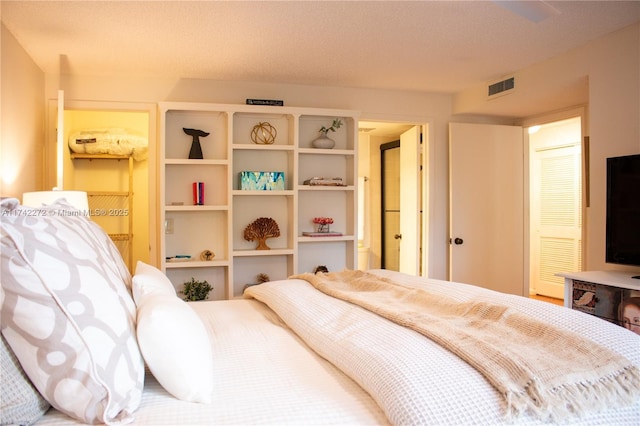 bedroom with visible vents and a textured ceiling