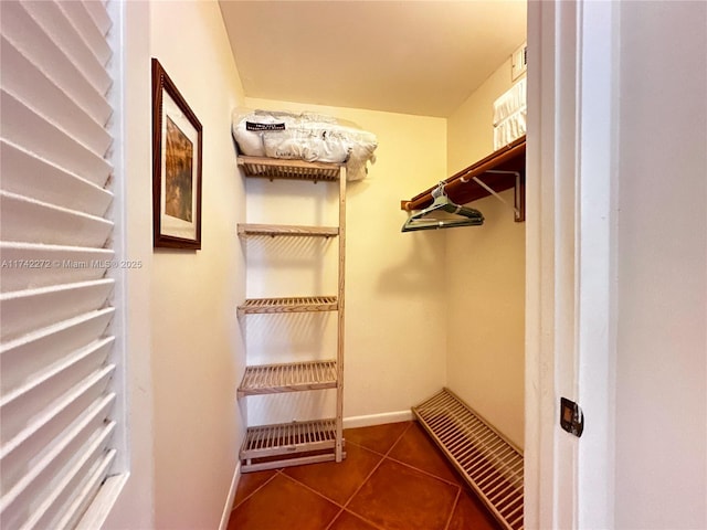 walk in closet with tile patterned flooring