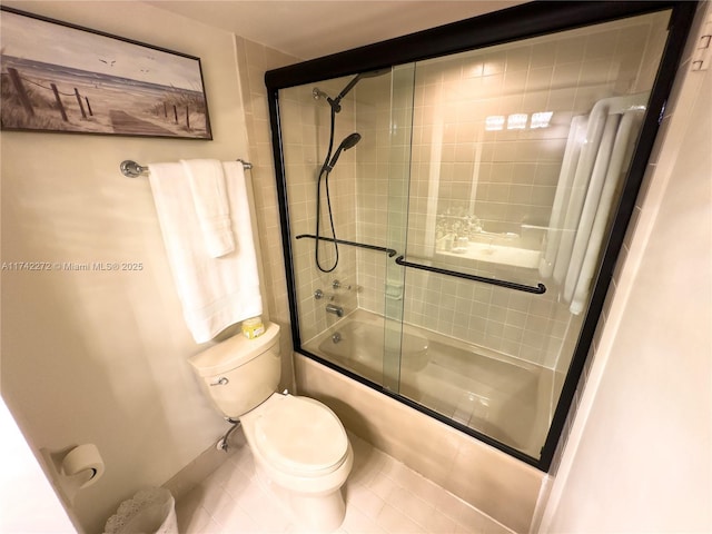 bathroom with enclosed tub / shower combo and toilet