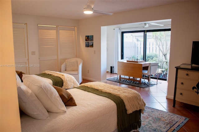 tiled bedroom featuring access to exterior, a ceiling fan, and baseboards