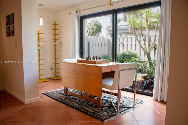 dining room featuring light tile patterned floors and baseboards