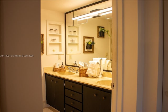 bathroom with a sink and double vanity