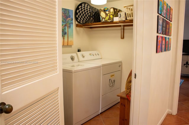 clothes washing area with laundry area, light tile patterned floors, and independent washer and dryer