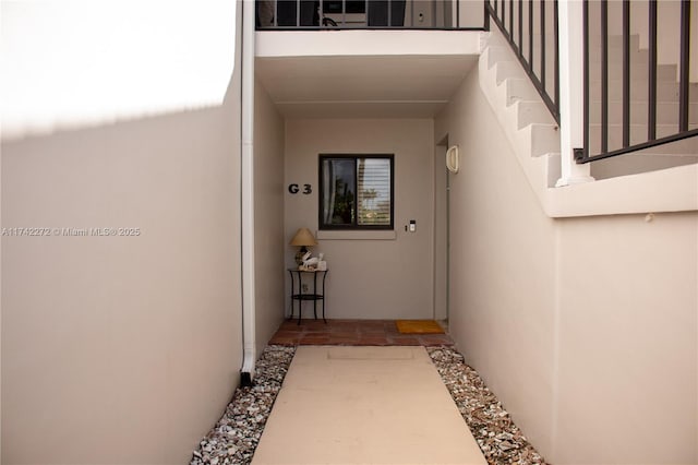 property entrance with stucco siding