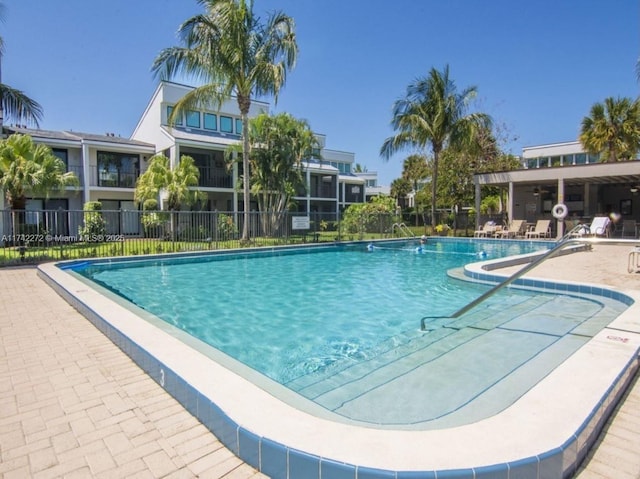 community pool featuring a patio area and fence