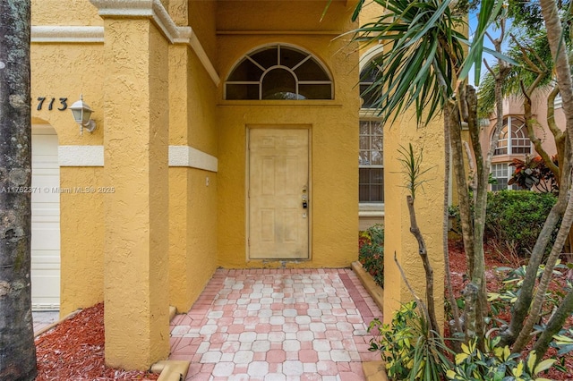 doorway to property with stucco siding