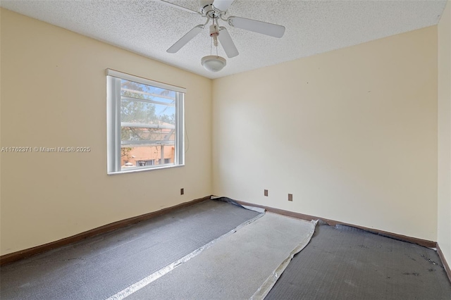 empty room featuring ceiling fan, a textured ceiling, and baseboards