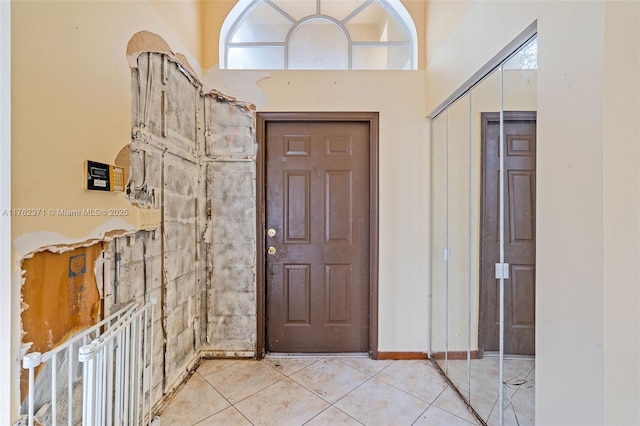 foyer entrance with light tile patterned floors