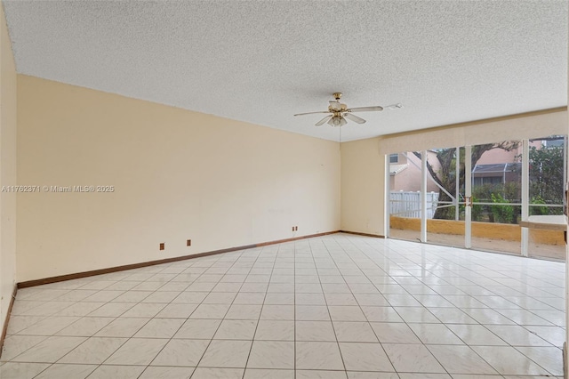 unfurnished room with a textured ceiling, light tile patterned flooring, baseboards, and ceiling fan