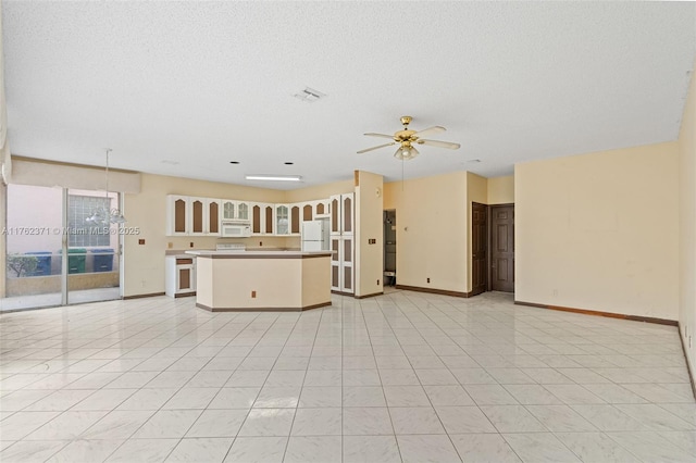 unfurnished living room featuring visible vents, baseboards, light tile patterned flooring, a textured ceiling, and ceiling fan with notable chandelier