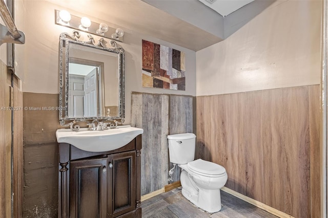 half bathroom with vanity and toilet