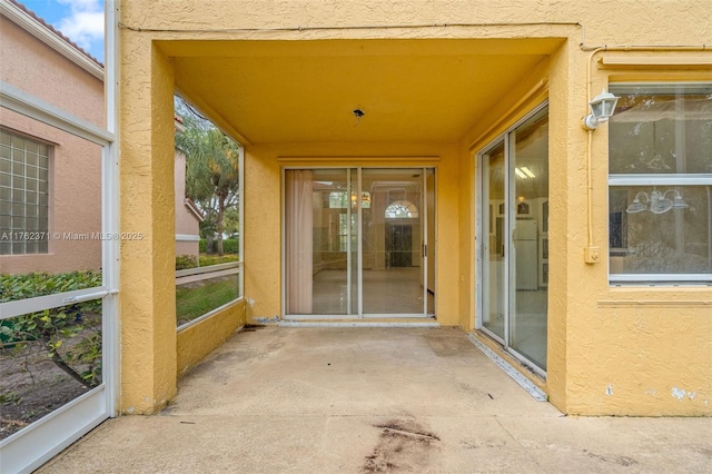 property entrance with stucco siding