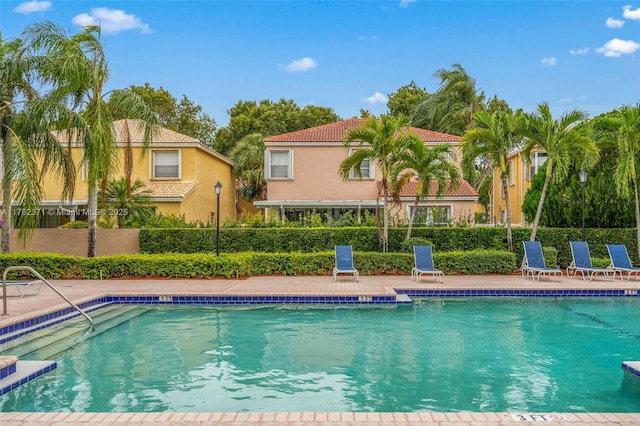 pool with a patio and fence