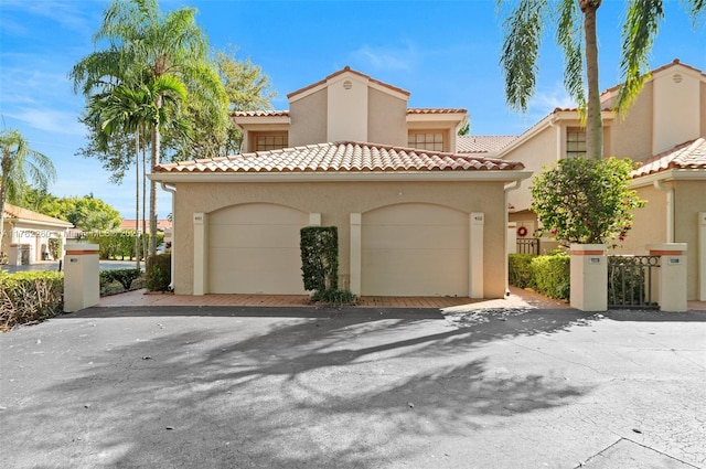 mediterranean / spanish-style house with stucco siding and a tile roof