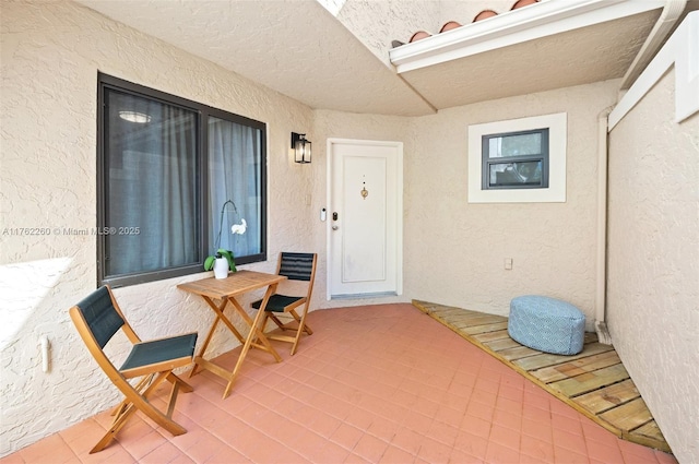 view of exterior entry featuring stucco siding