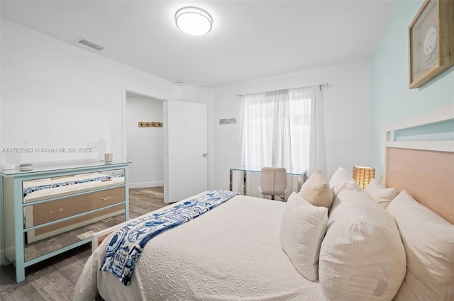 bedroom with wood finished floors and visible vents