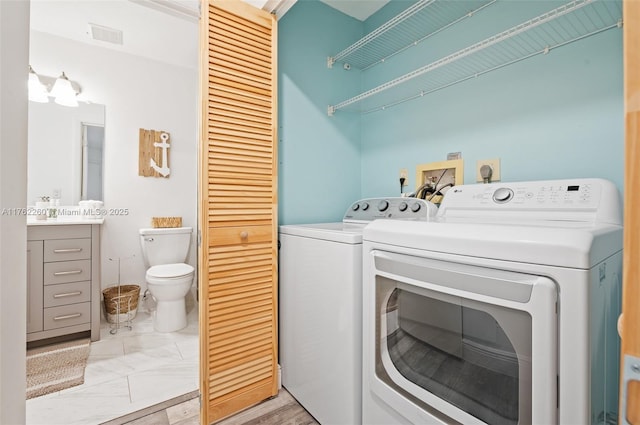 laundry area featuring washer and dryer, visible vents, and laundry area