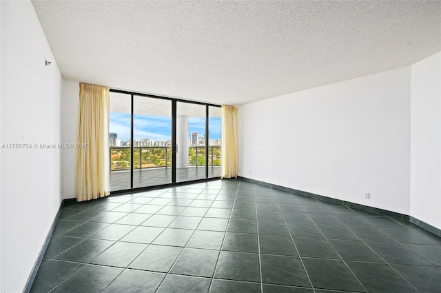 3600 Yacht Club Dr Unit 1102, Aventura, FL 33180 - empty room with dark tile patterned flooring, floor to ceiling windows, baseboards, and a textured ceiling