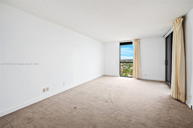 3600 Yacht Club Dr Unit 1102, Aventura, FL 33180 - carpeted spare room featuring floor to ceiling windows, baseboards, and a textured ceiling
