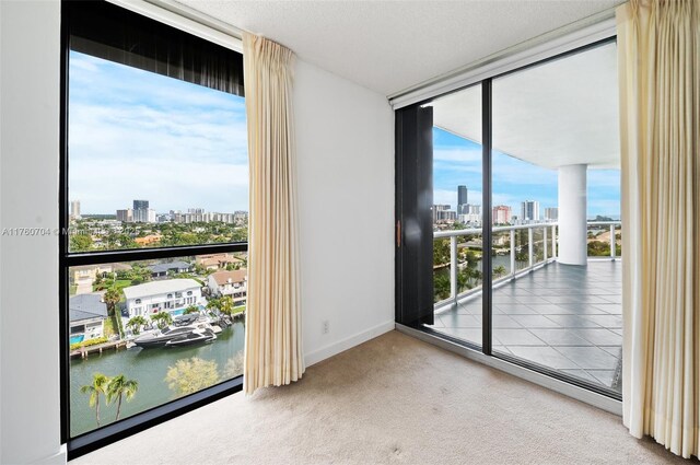 3600 Yacht Club Dr Unit 1102, Aventura, FL 33180 - spare room with a city view, floor to ceiling windows, baseboards, and carpet floors