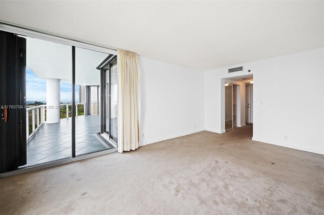 3600 Yacht Club Dr Unit 1102, Aventura, FL 33180 - carpeted empty room featuring a textured ceiling, baseboards, visible vents, and expansive windows
