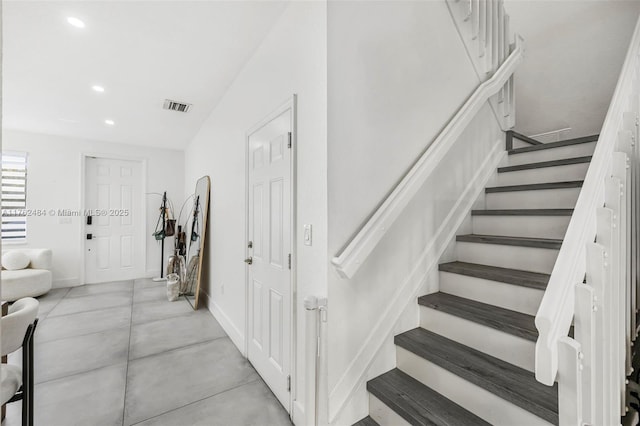 stairway with recessed lighting, visible vents, and baseboards