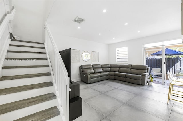 living area with stairway, recessed lighting, visible vents, and a wealth of natural light