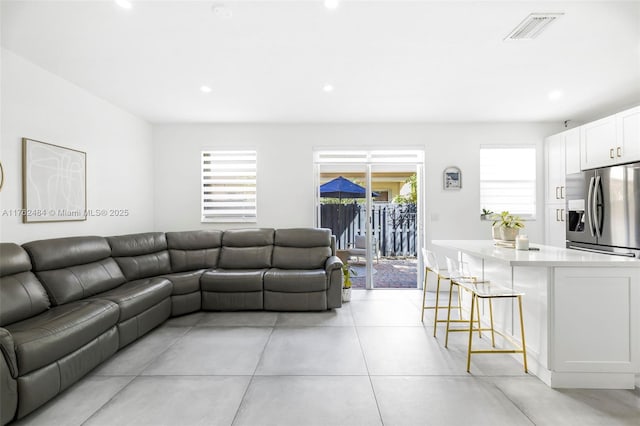 living room featuring recessed lighting and visible vents