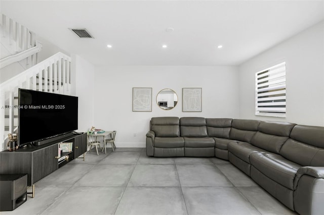 living room with recessed lighting, visible vents, and baseboards