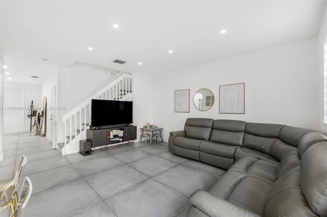 living room featuring stairway, recessed lighting, and visible vents