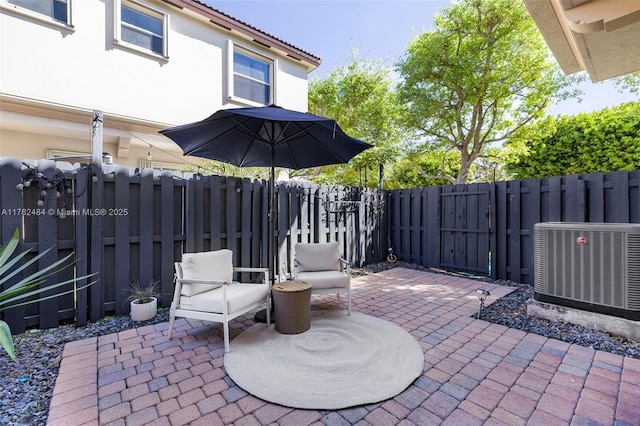 view of patio / terrace with a fenced backyard and central AC