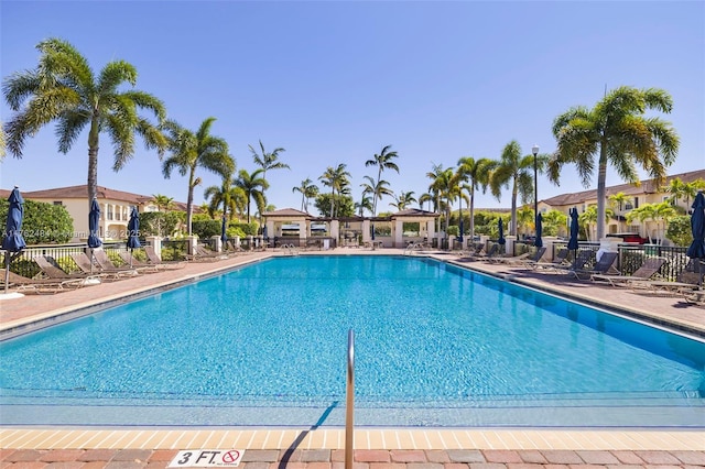 pool with a gazebo, a patio area, fence, and a residential view