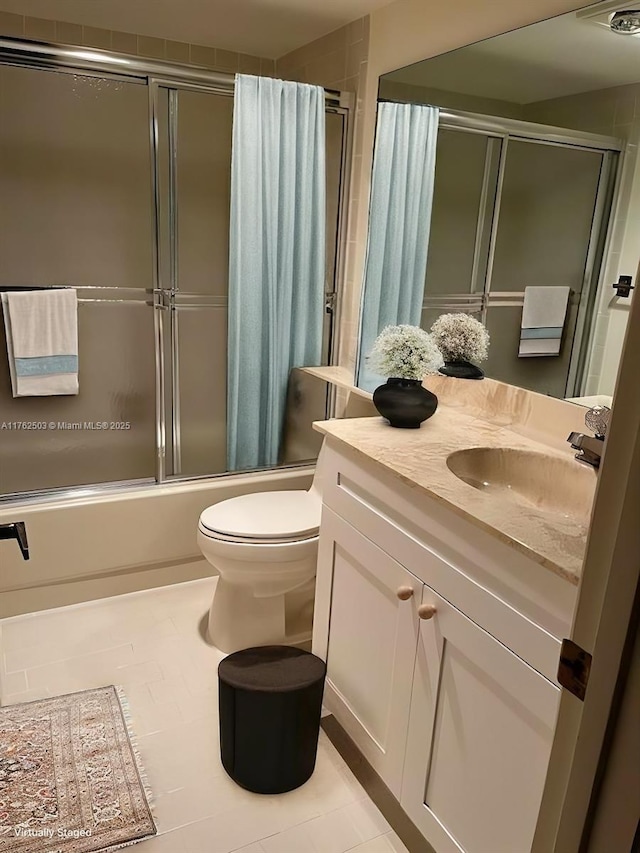 bathroom featuring tile patterned flooring, visible vents, toilet, shower / bath combination with glass door, and vanity